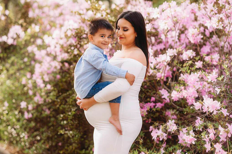 Expectant mother holds her toddler during Maternity Portrait Session in Charleston, SC.