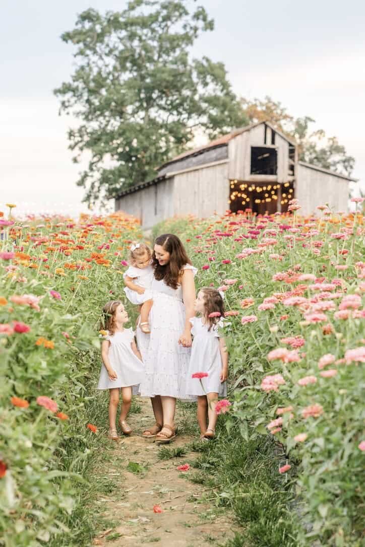 Chattanooga photographer Kelley Hoagland holds her daughter's in a flower field.