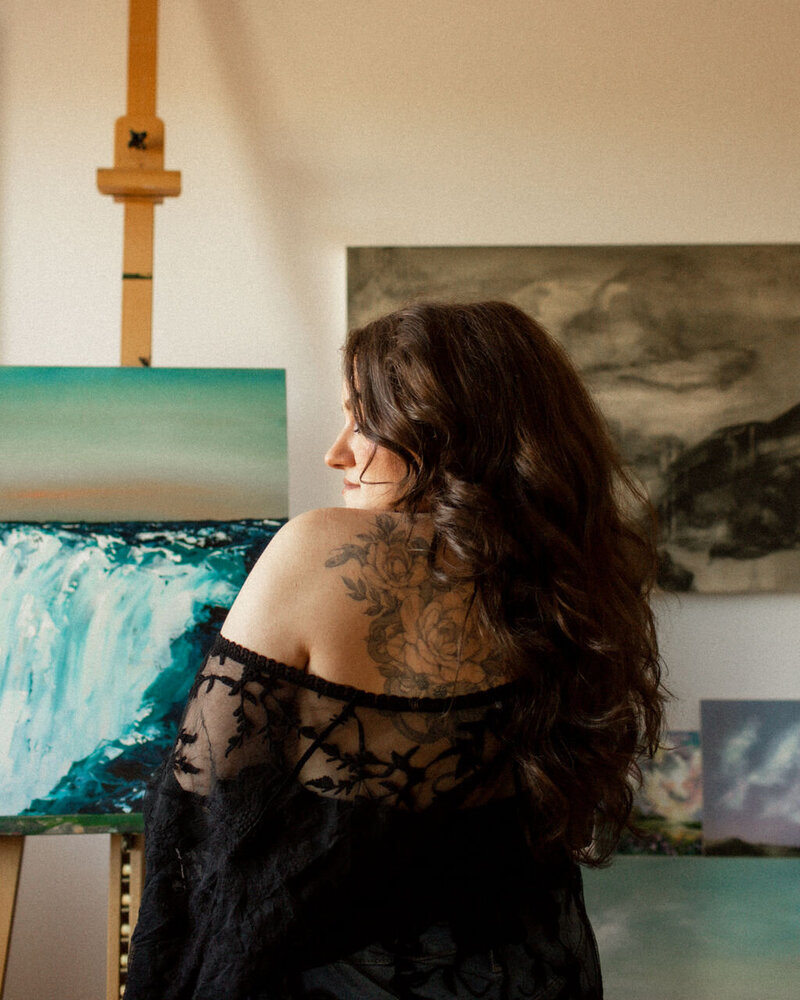 A creative professional standing in an art studio, symbolizing the strategic and personalized approach to SEO-optimized monthly blogging services.