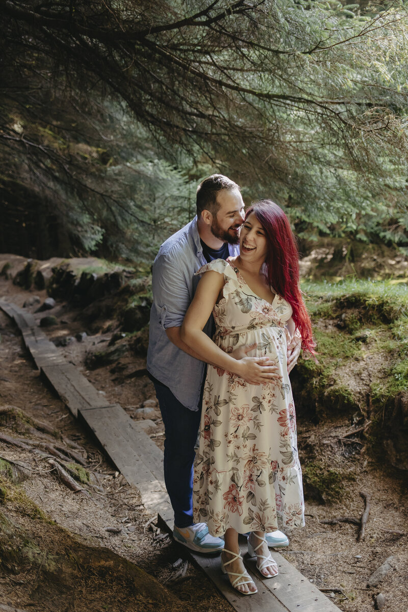 Maternity photoshoot in the scenic landscape of Wicklow, with the mother-to-be gently cradling her baby bump surrounded by nature.