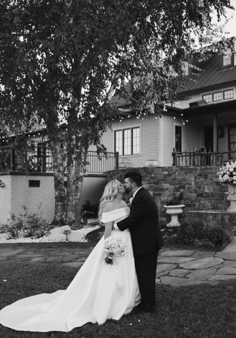 Bride and Groom kissing in front of Danclay Farms