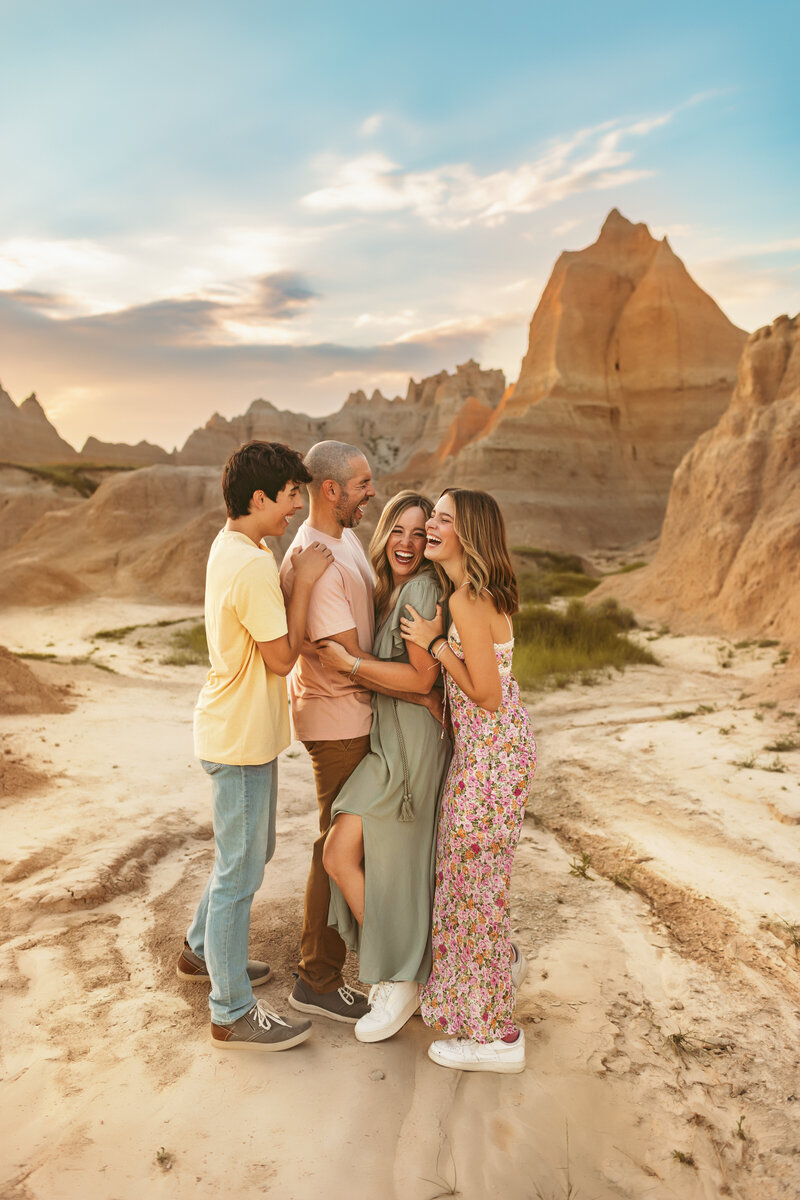 Family photos in Badlands South Dakota snuggle up and laugh together in photoshoot taken by Maternity Kansas City Photographers.