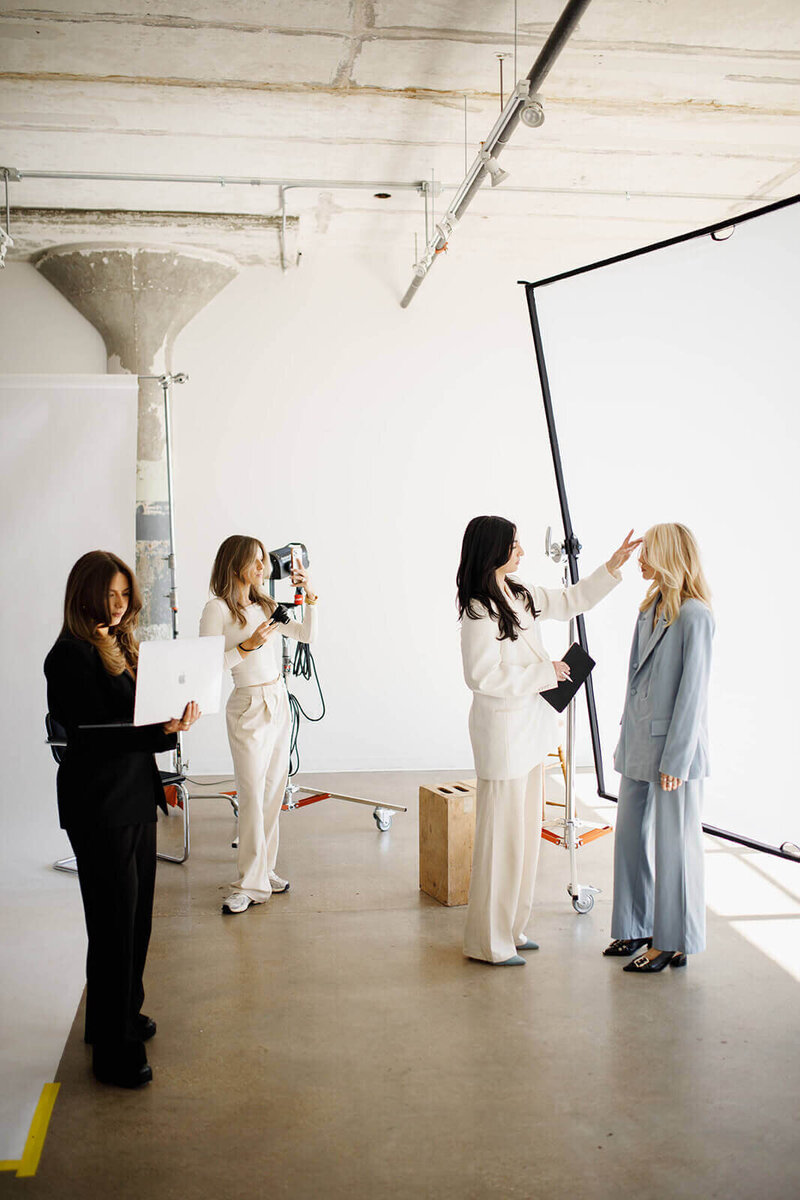 A team working together to style and direct a photoshoot 