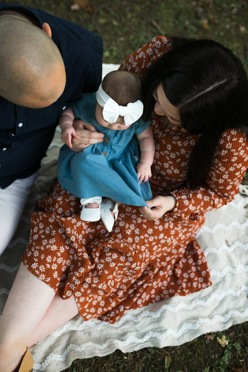 Family photo with mom, dad, and newborn baby.