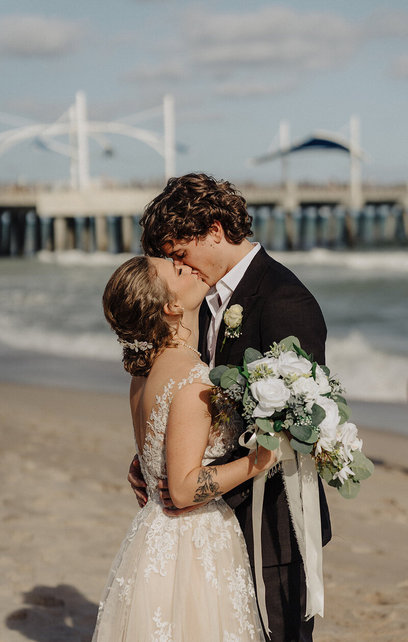 bride and groom kissing  florida beach wedding