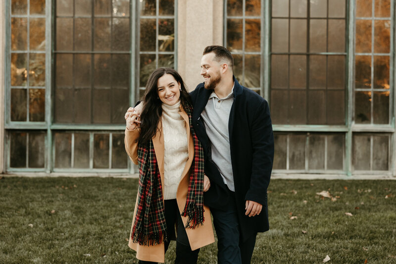 Couple walking with fiance arm around girl walking and laughing