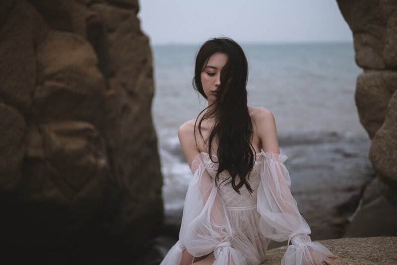 A beautiful windswept beach couture shoot amongst coastal rocks.