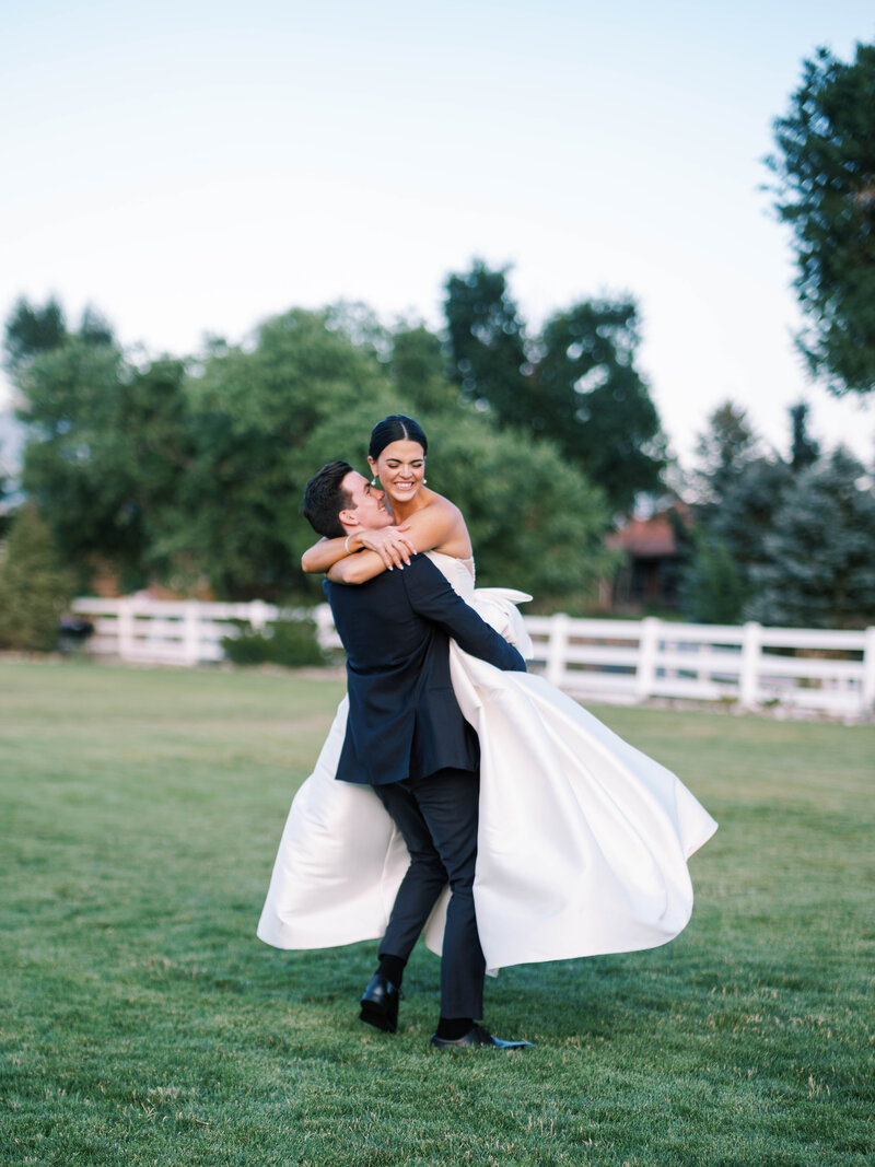 Bride and groom holding hands at Lafayette Park  outside by Colorado wedding Photographer JKG Photography