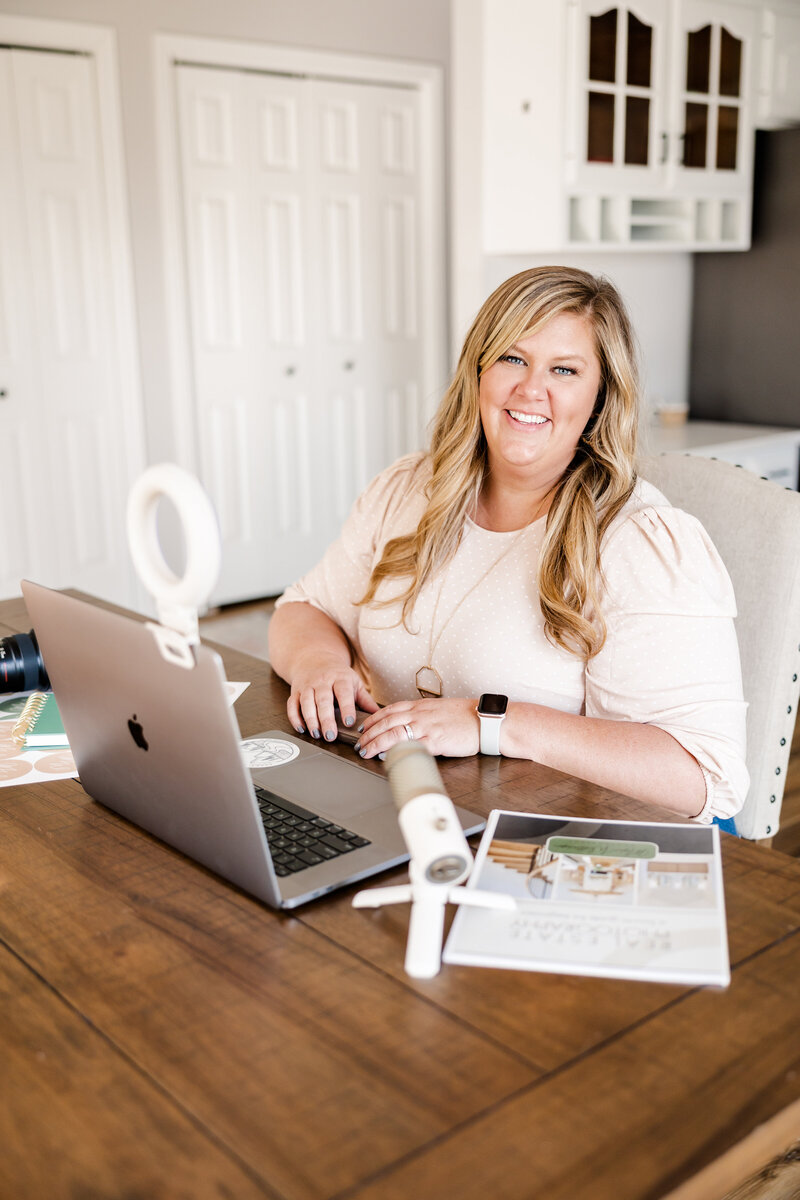 A candid shot of Meg Williamson smiling warmly as she works on her editing. The image captures her friendly and approachable nature, reflecting her passion and dedication to her craft.