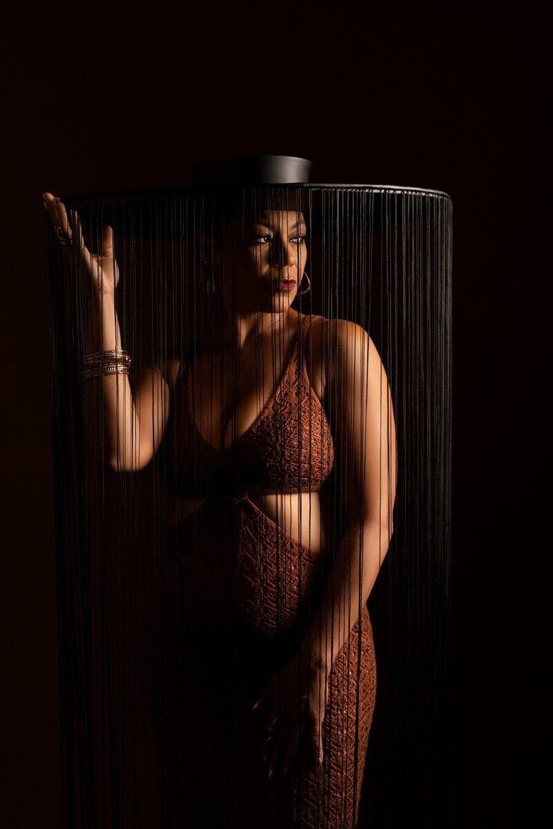 A woman poses in a showstopping white dress for the 40 over 40 project