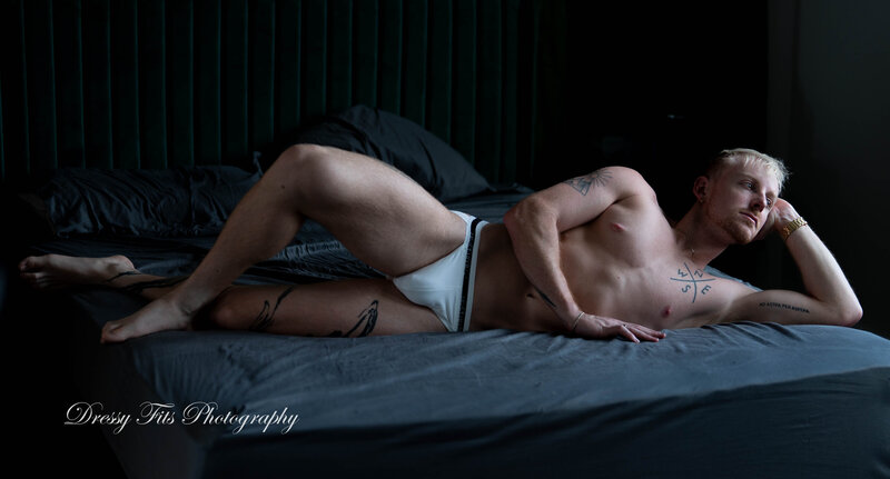 Houston Boudoir man laying on bed dark background
