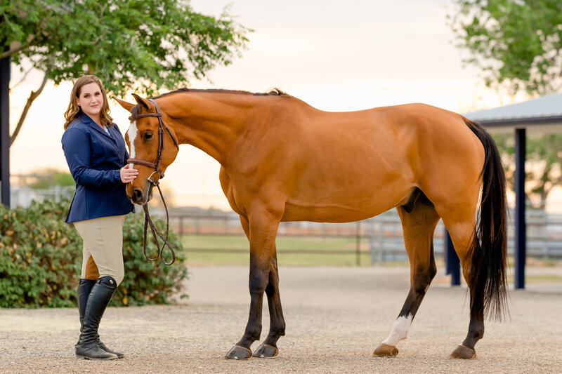 On The Mark Equestrian hunter jumper client Ellen Dailey poses with her bay gelding at Williams Equestrian Center in Midland Texas