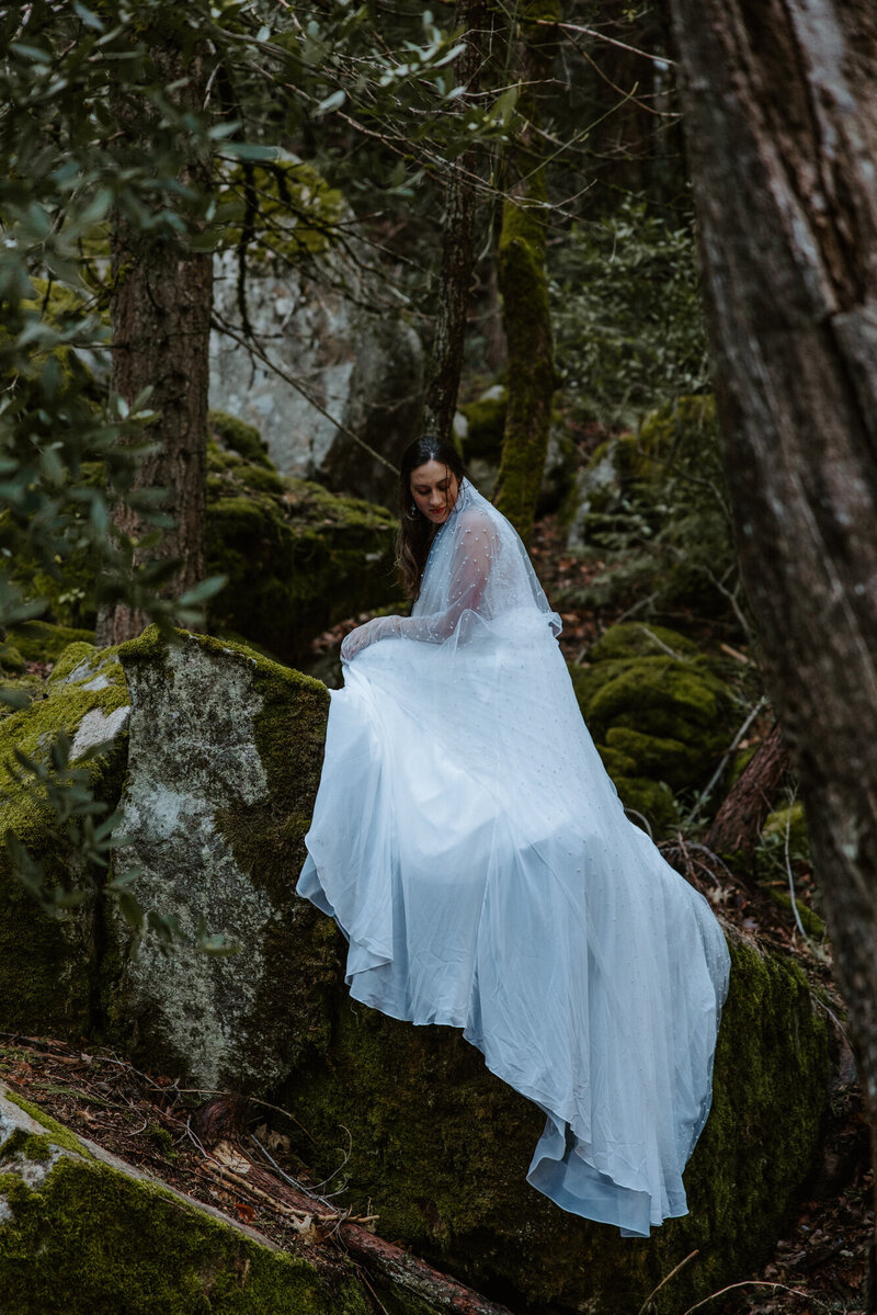 Bride eloping in mossy forest trail in Washington