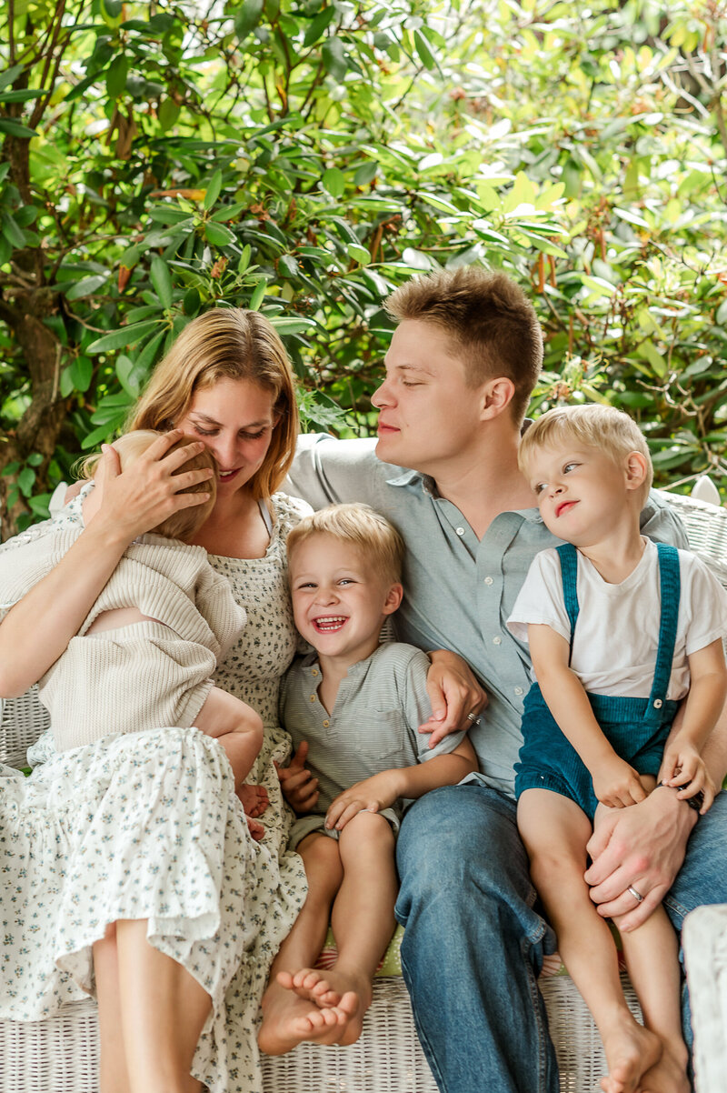 Family of 5 sitting together on their front porch by york and lancaster photographer