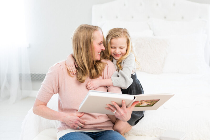 Mom and daughter look at their photo album in Boise.