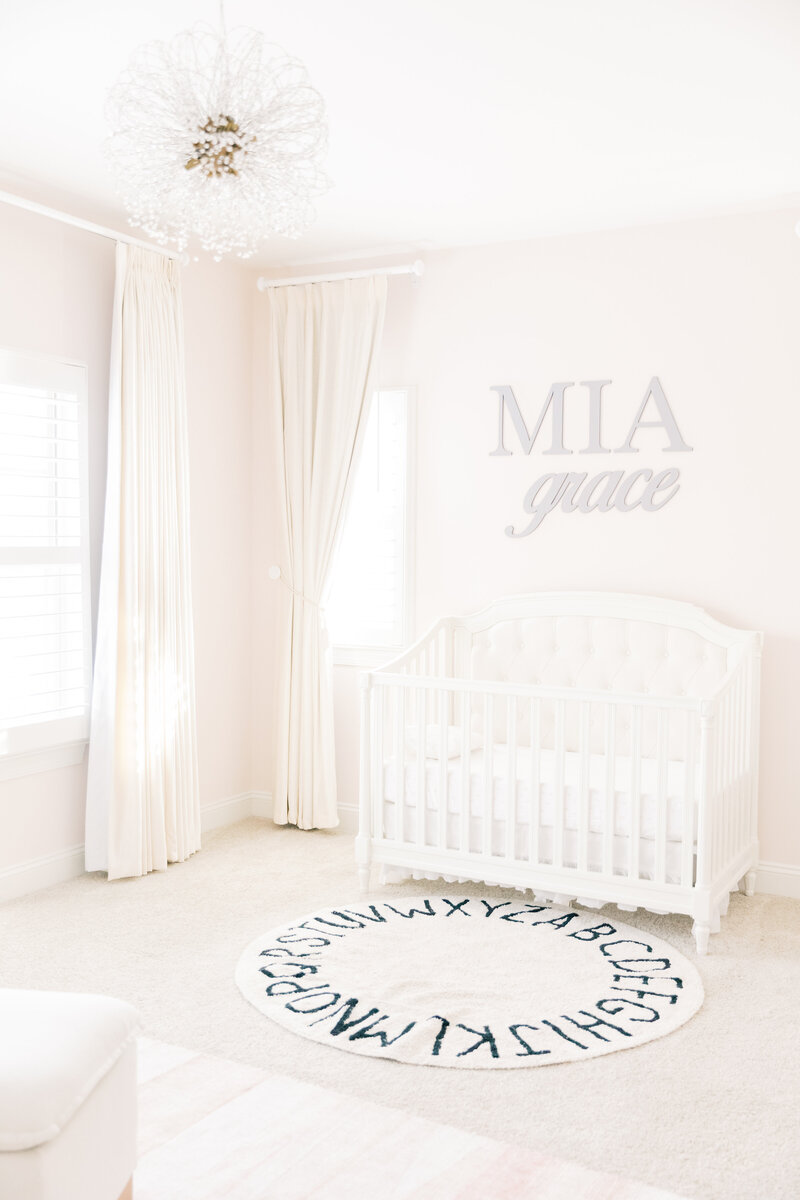 A look at a nursery crib with custom wall art