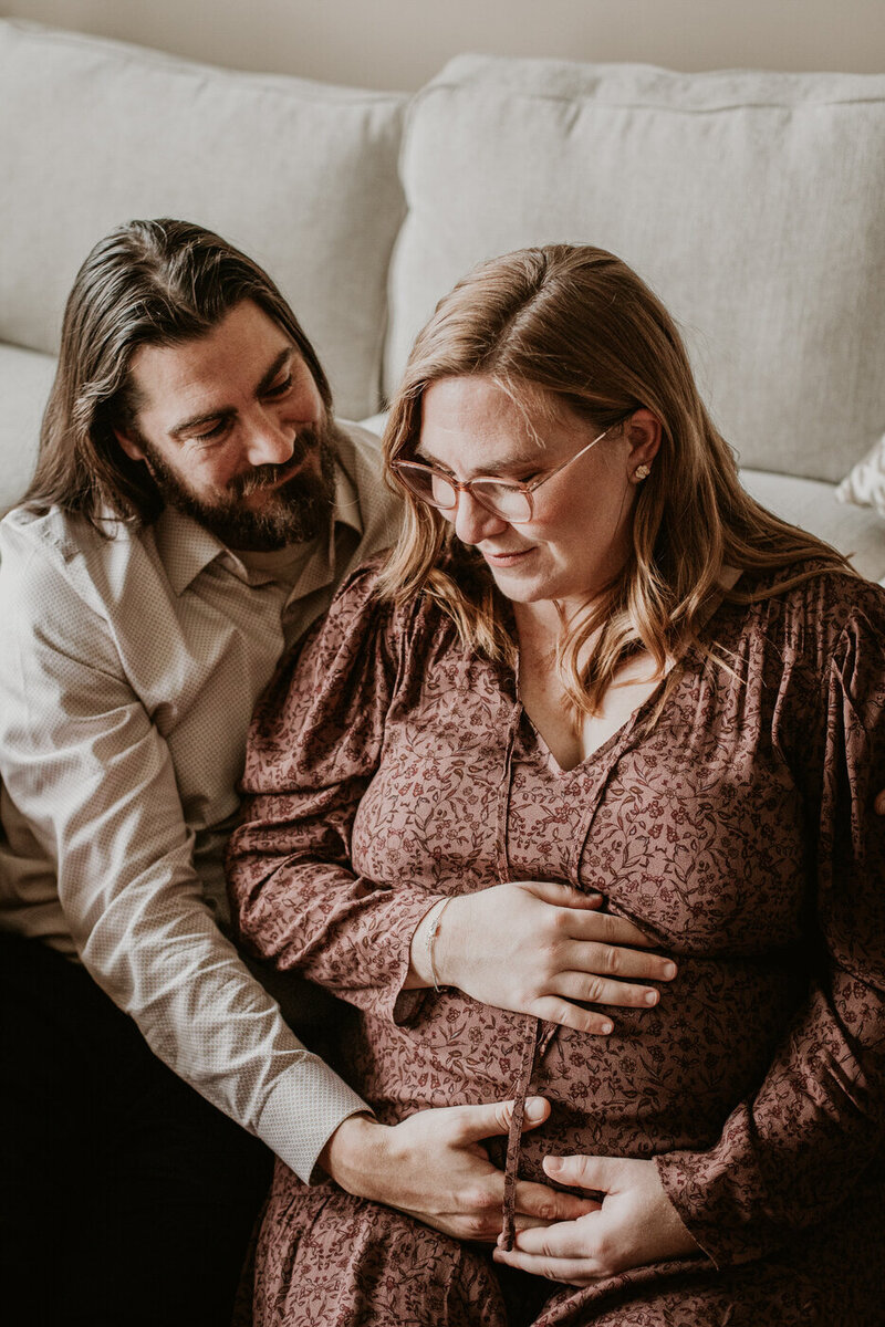 Cozy at home maternity photos in Winnipeg with mom to be in flowy dress 