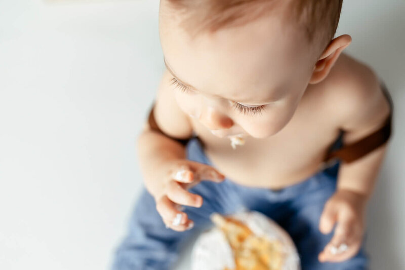 Detail shot of a toddler's eyelashes while he is eating cake.
