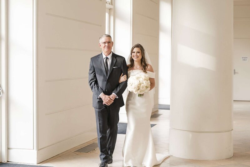 Father of the bride is walking the bride down the aisle captured by Fort Myers Wedding Photographers