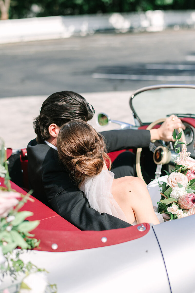bride and groom in car