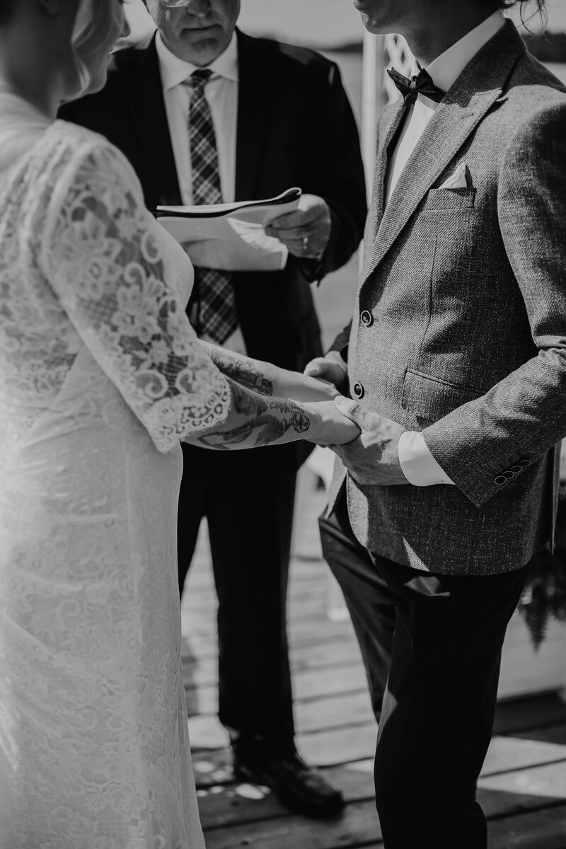 bride-holding-grooms-hand
