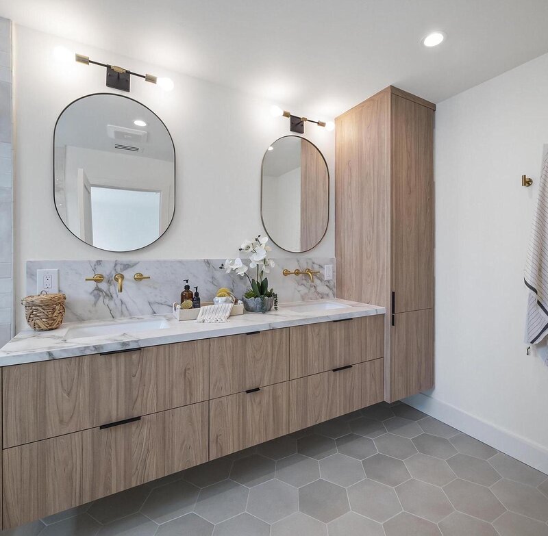 Bathroom interior design having 2 sinks and oval mirrors