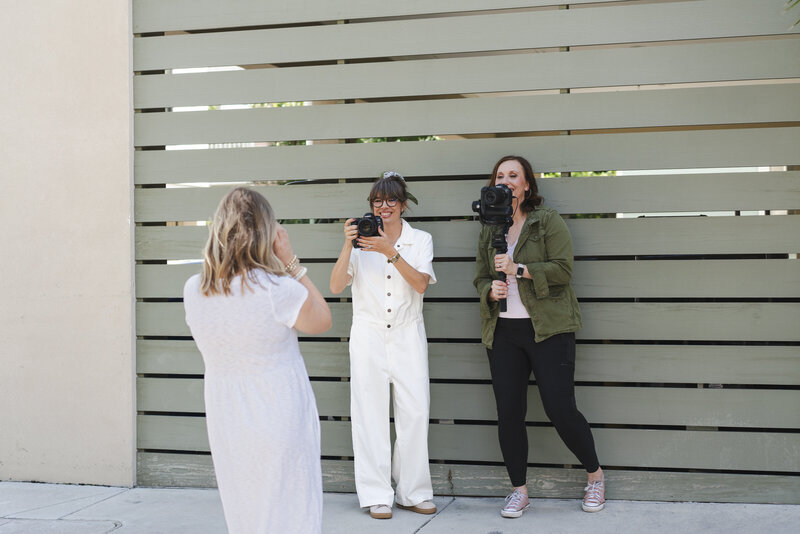 female-brand-photography-videography-team-filiming-client-for-brand-session-Charleston