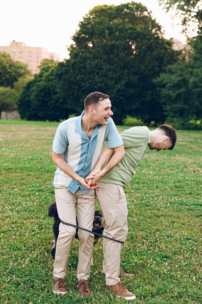 A queer couple and their adorable dog at their engagement session at Promontory Point in Chicago