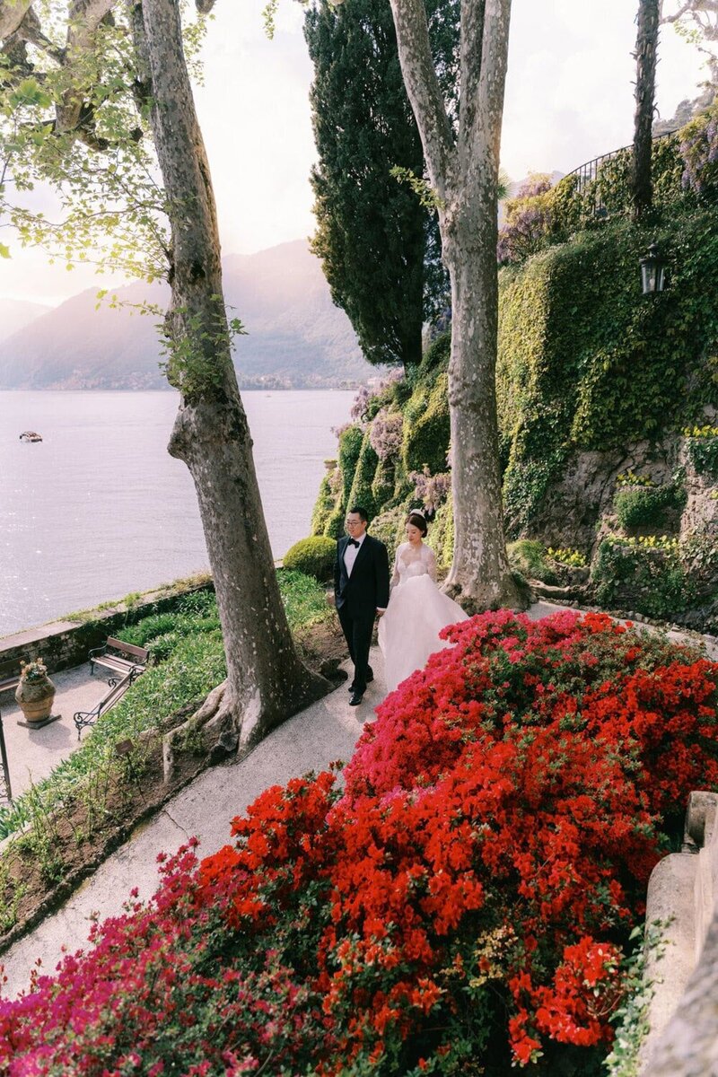 Couple walking in front of lake during a villa del Balbianello wedding, by Lake Como destination wedding photographer Andreas K. Georgiou  