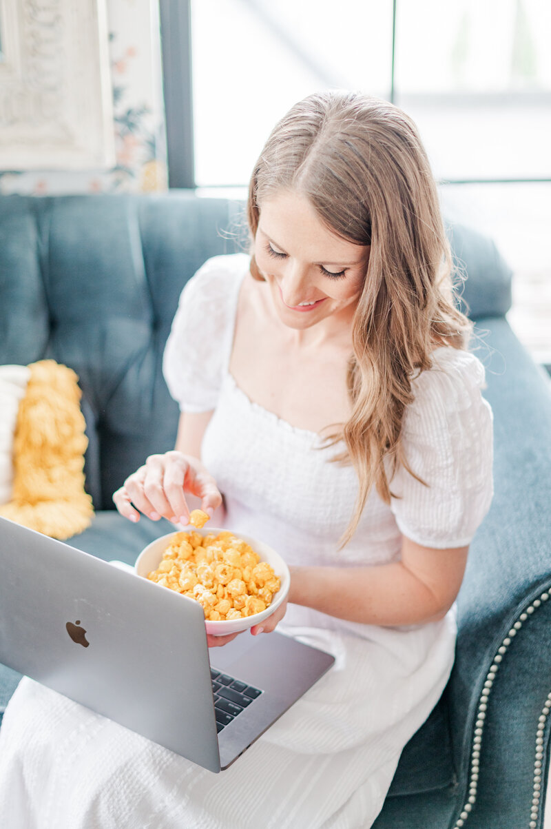 Kaitlin Mendoza eating popcorn photographed by Kaitlin Mendoza Photography, an Indianapolis wedding photographer