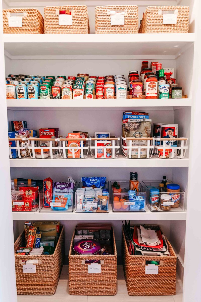 The inside of a pantry, featuring various organizing product and neatly organized food products