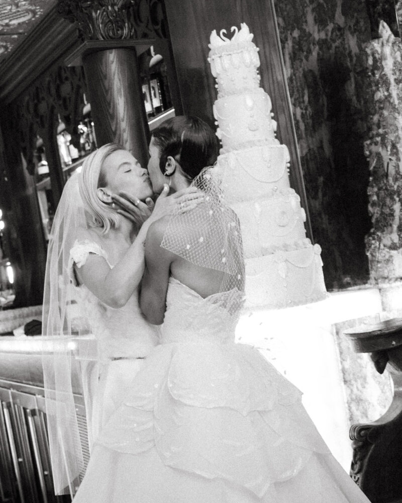 Maid of honor applies bride's makeup, captured by Oahu wedding photographer.