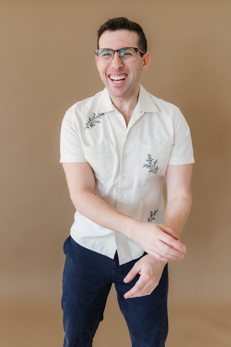 A person sitting on a ledge laughing