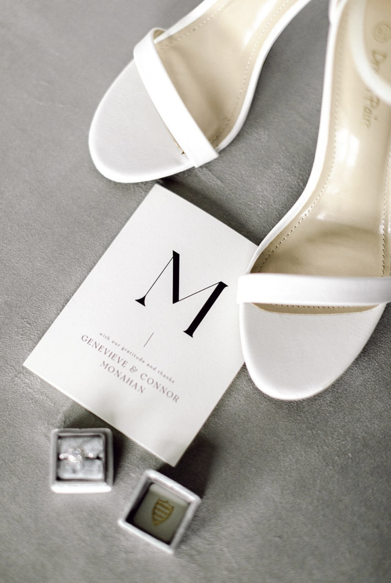 Silver suede flat lay mat with elegant wedding accessories and metallic accents