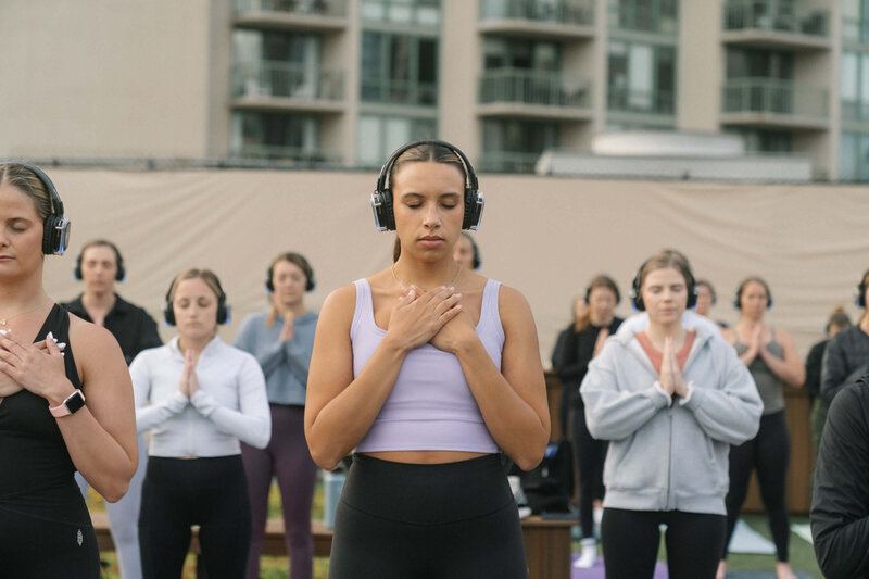 Group of females with their hands on heart during a meditation