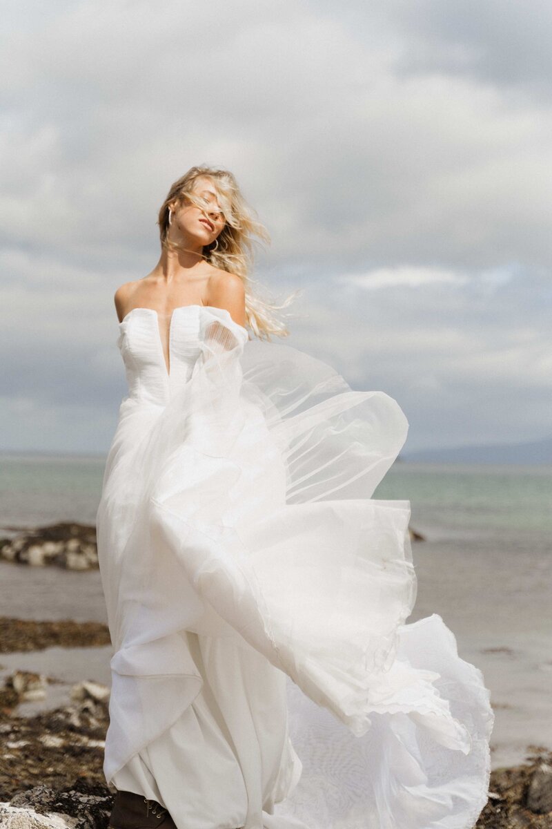 bride with windswept hair and dress close to water in Charlotte