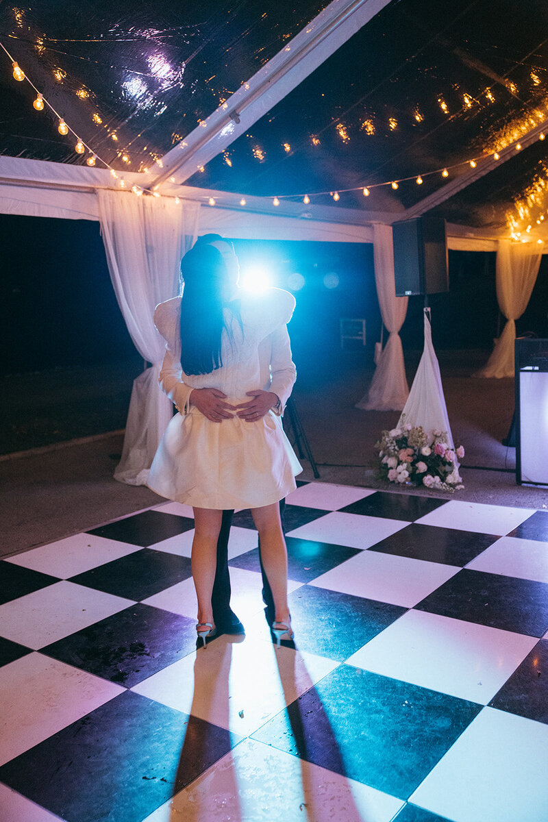 Newlyweds have a final slow dance to their favorite song on a checkered black and white dance floor at Trinity View Farms in Franklin, TN.