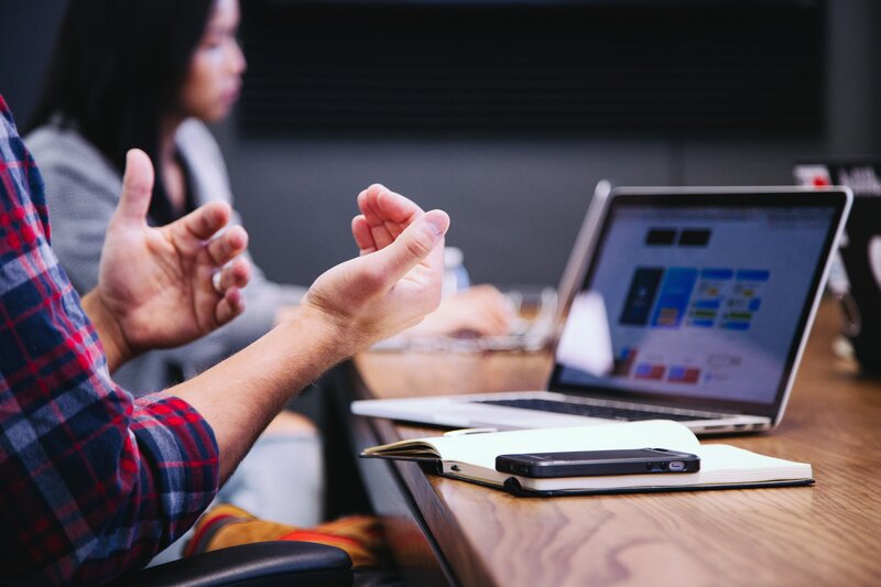 Man gesturing while explaining his business in a pitch meeting