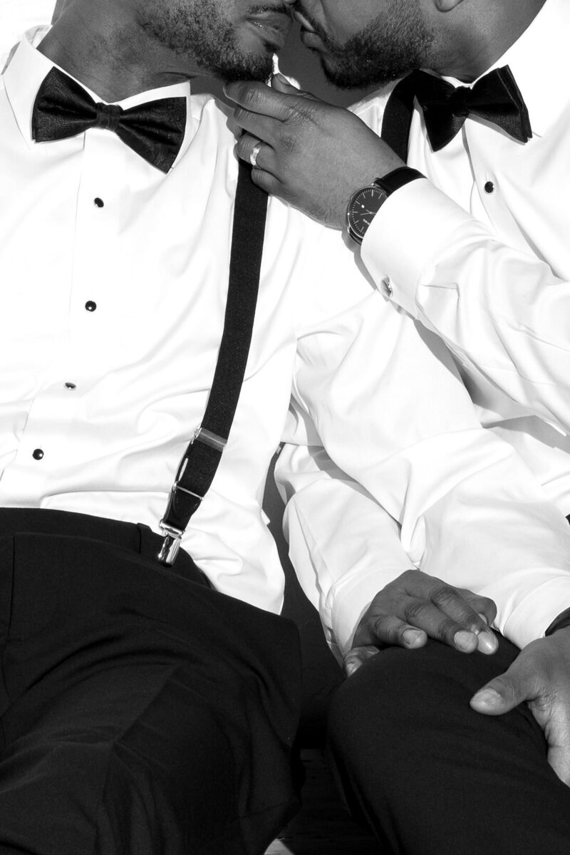 Queer couple kissing and holding hands Q Jancola