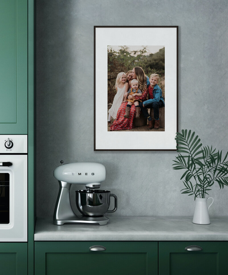 framed photo of mother and children over kitchen countertop