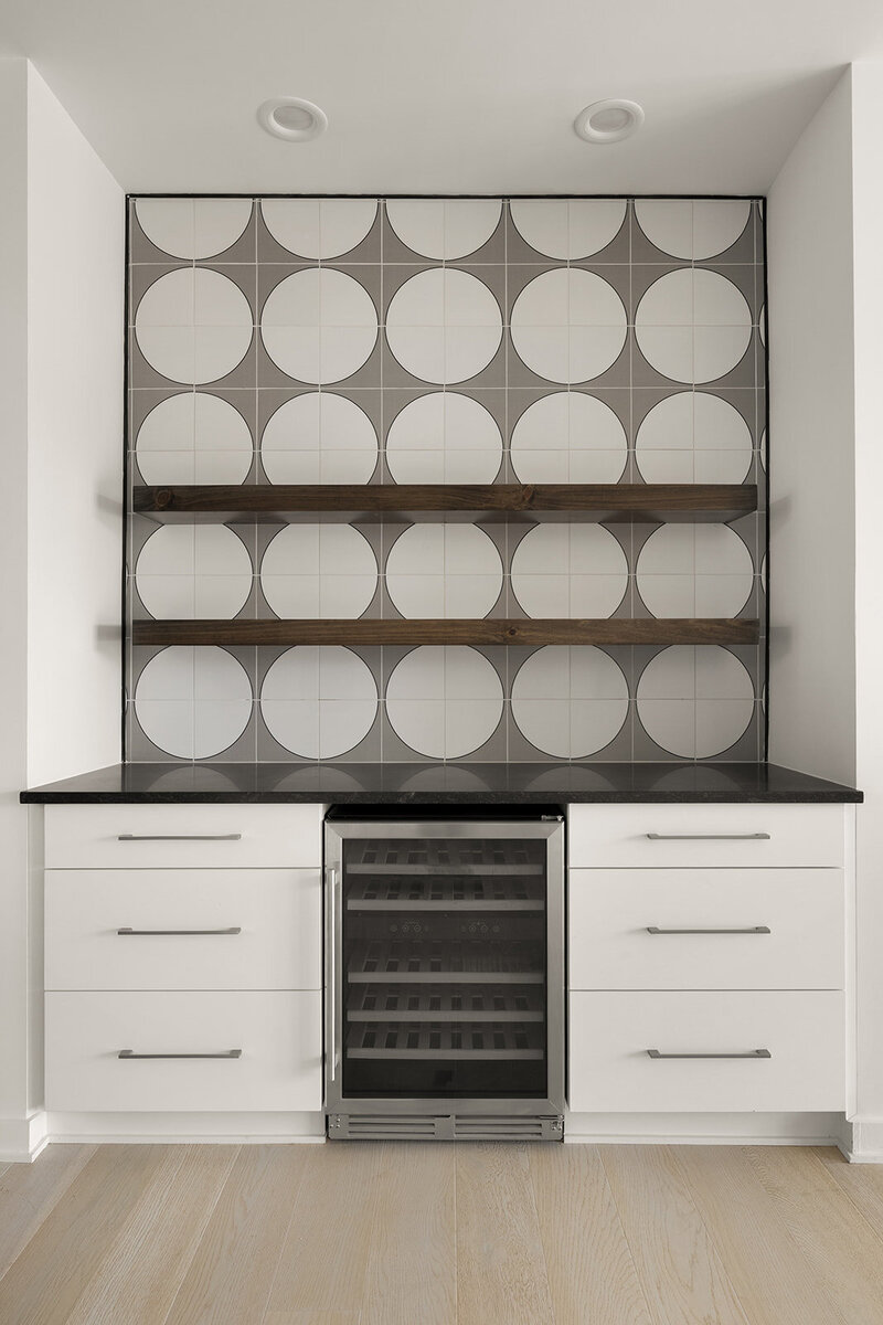 circle tile backsplash in kitchen bar with floating shelving