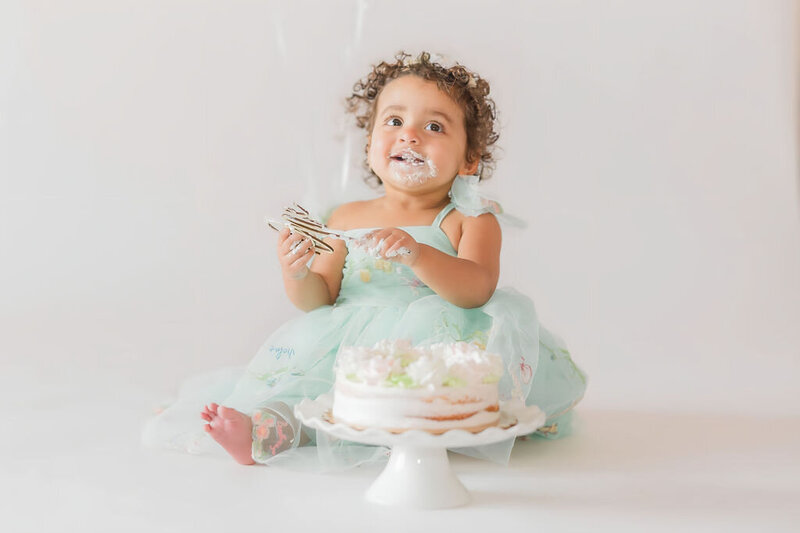 Cake smash during first birthday milestone session in Huntersville NC