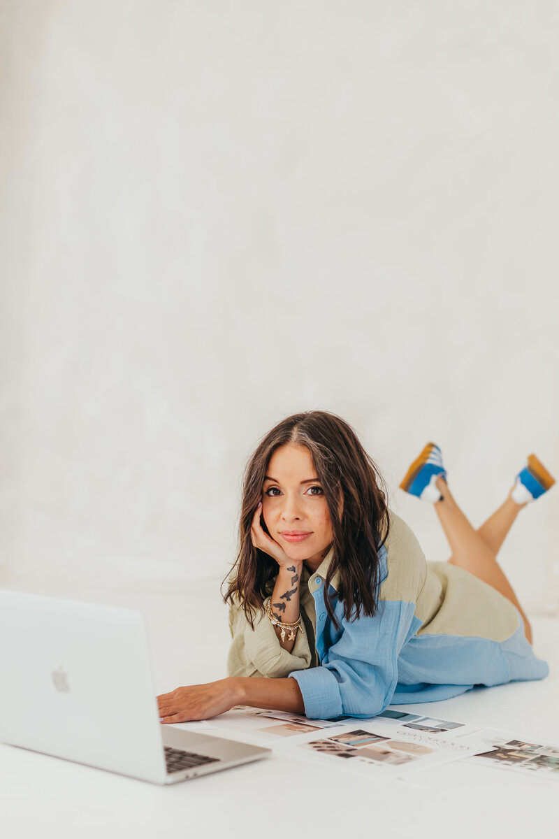 Laid-back but lethal-legs up, laptop open, and ready to design something loud in brand colors, fonts, and logos.