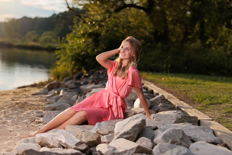 Lake Raleigh Teen Portraits sitting on the rocks by the water.