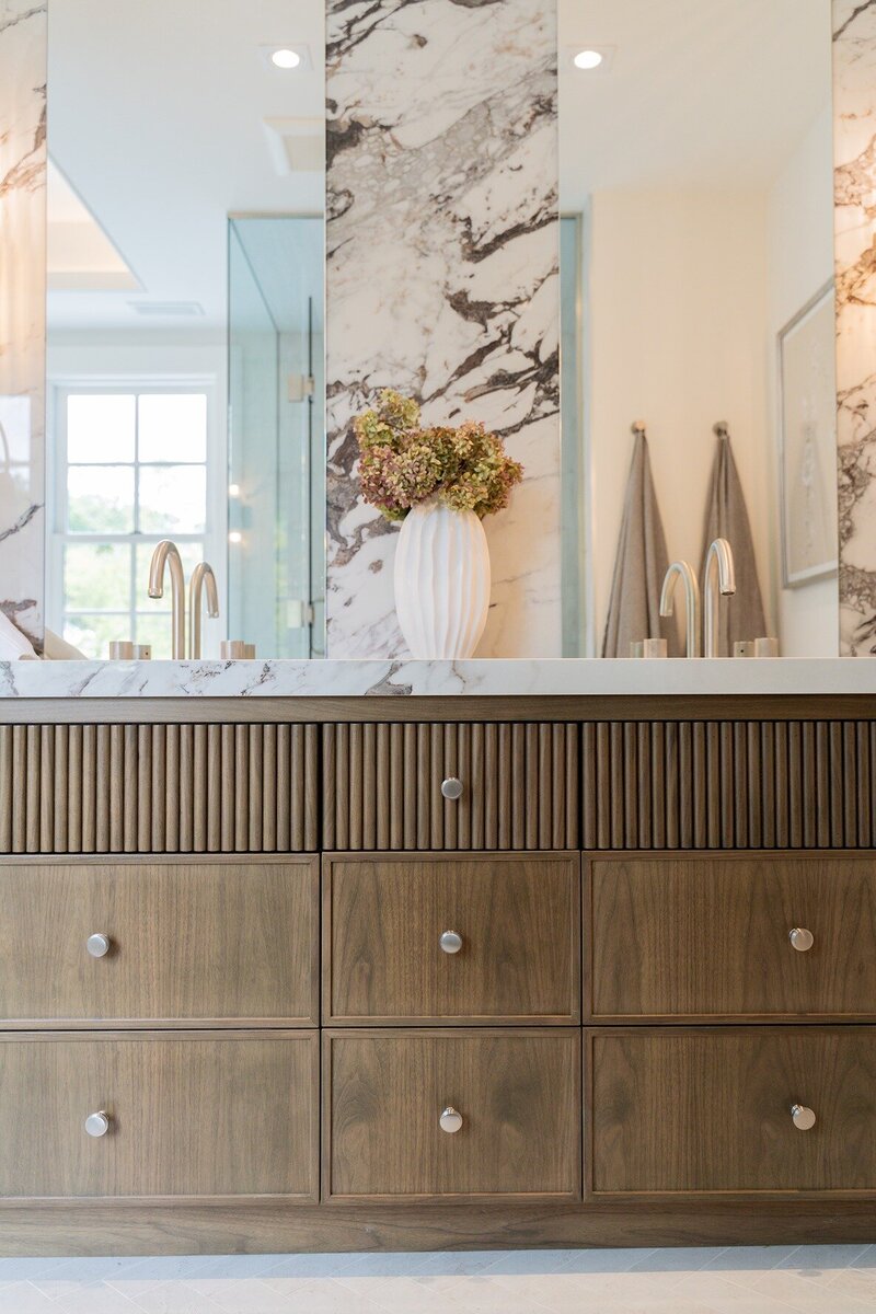 Bathroom cabinets with marble countertops and wooden finishing