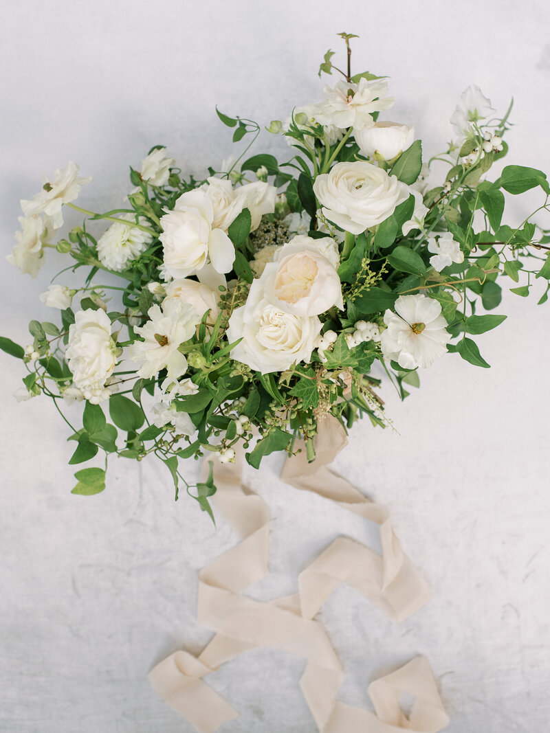 Bride and groom hold white organic bouquet at Cairnwood Estate Wedding