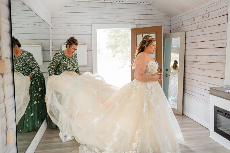 bride getting her dress fluffed by her mother for her colorado wedding