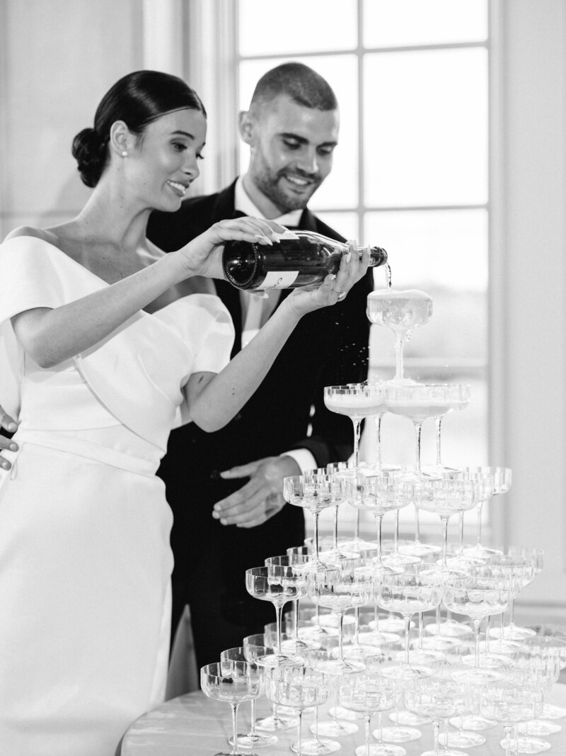 Bride pours champagne on the champagne tower