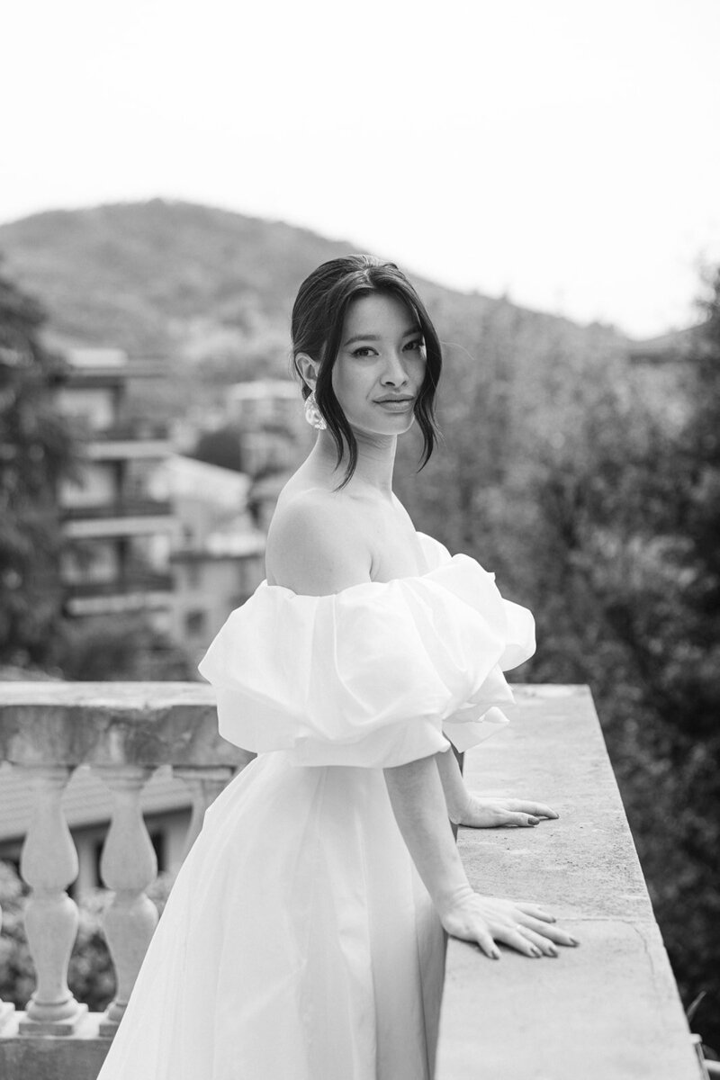 a bride posing on a balcony
