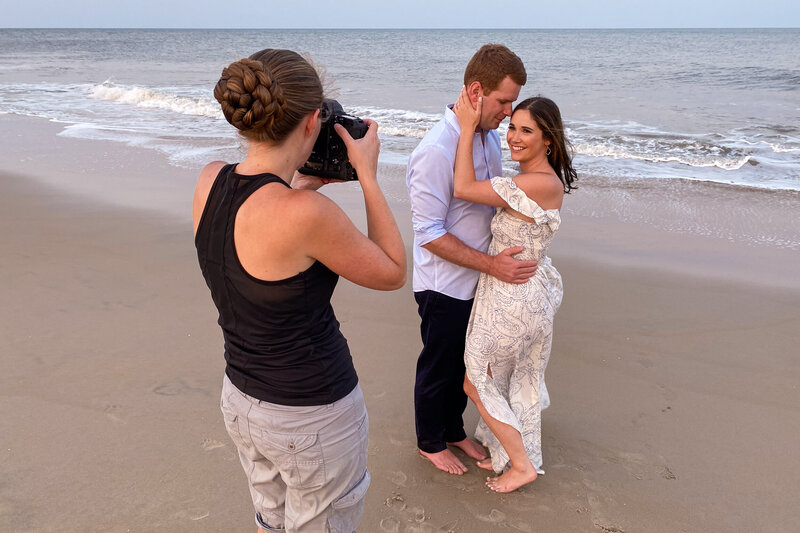 Jen Stitt capturing a romantic moment of an engaged couple on a picturesque Maryland beach during an engagement session, showcasing her ability to blend natural beauty with timeless photography skills.